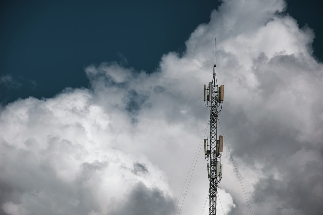 Cell tower against a cloudy sky